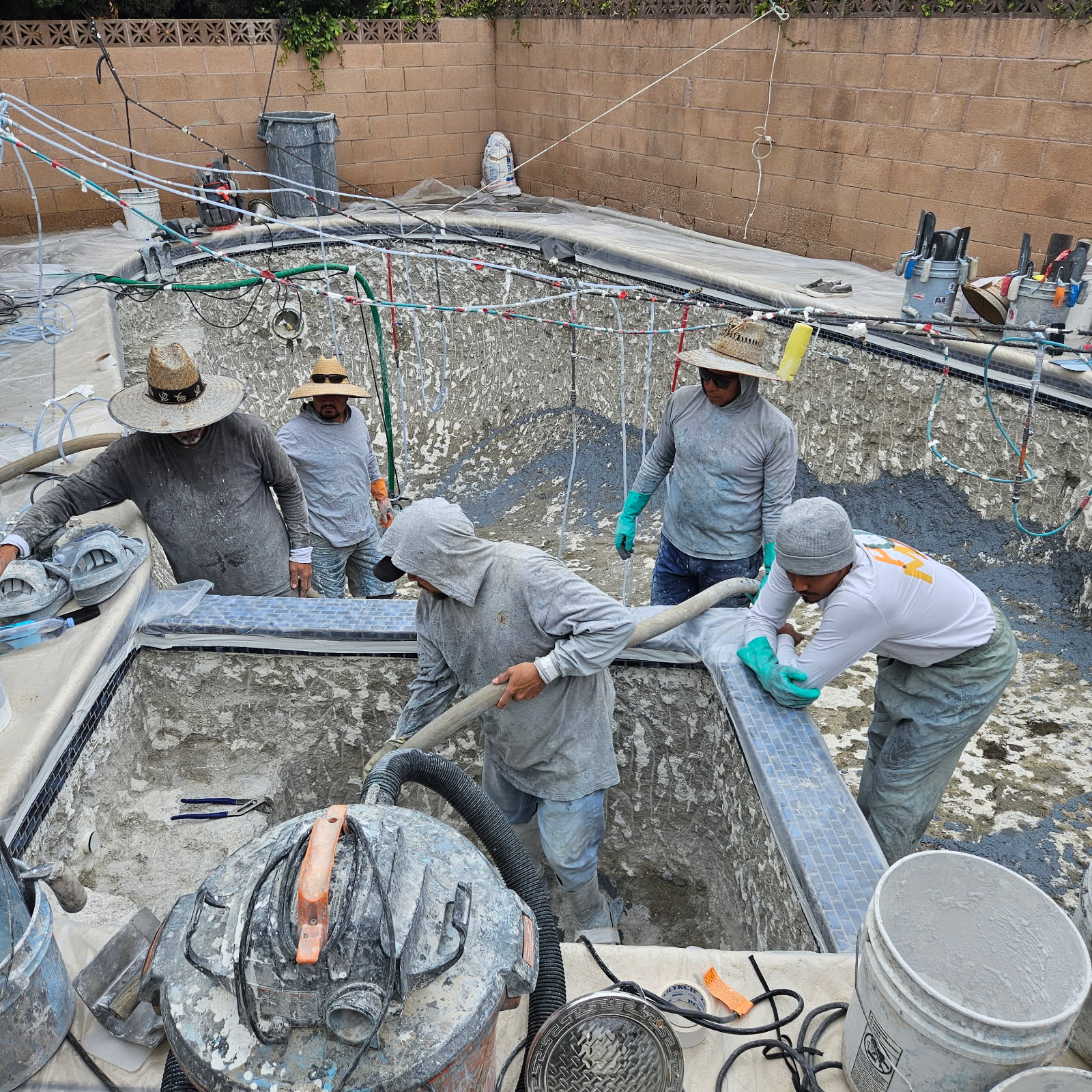 Pool plastering and replaster crew at work